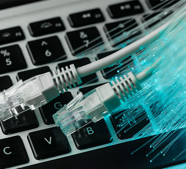footer_0003_blue-optic-fiber-with-ethernet-cables-laptop