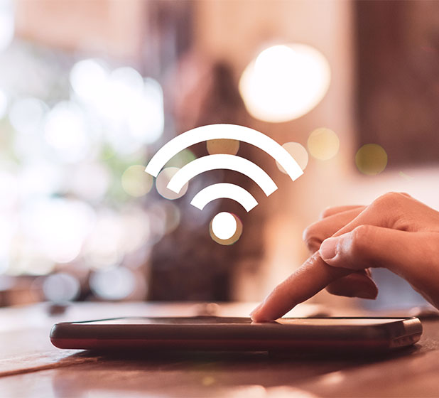 footer_0005_wifi-sign-icon-connection-screen-smartphone-with-top-view-city-background-financial-business-technology-free